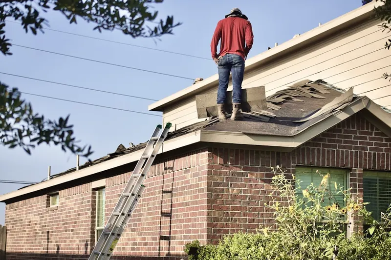 Professional roofer working on a residential roof in Villa Hills
